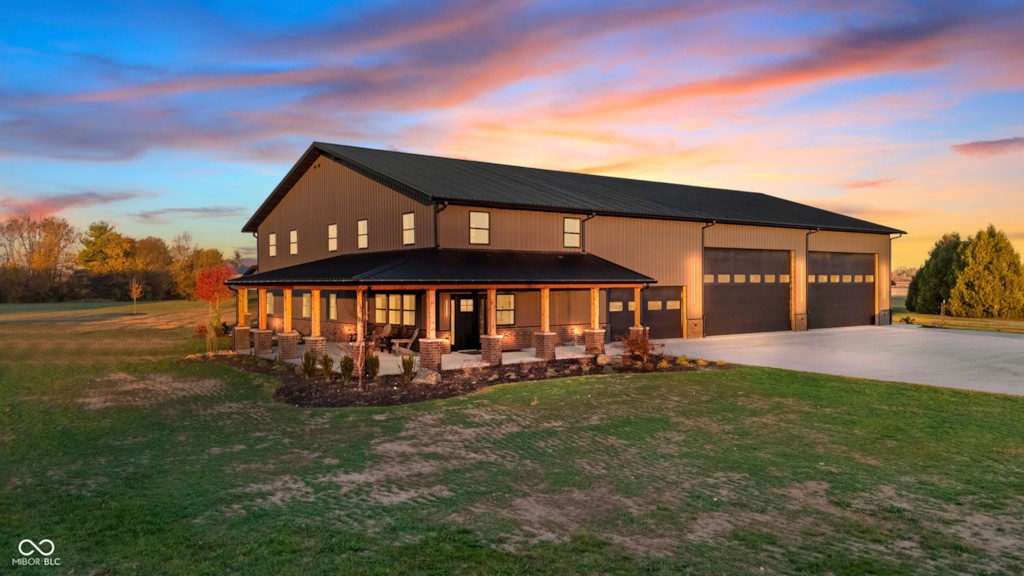 A custom home and attached garage at sunset
